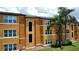 View of the apartment complex with well-maintained grounds and mature palm trees at 4606 Commander Dr # 1126, Orlando, FL 32822