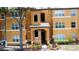 The front facade of a well-maintained apartment building with multiple windows and a landscaped entrance at 4606 Commander Dr # 1126, Orlando, FL 32822