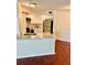 Well-lit kitchen with granite countertop bar, stainless appliances, and pendant lighting at 4606 Commander Dr # 1126, Orlando, FL 32822