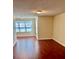 Spacious living room with wood flooring and large window providing natural light at 4606 Commander Dr # 1126, Orlando, FL 32822