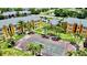Aerial view of a tennis court nestled among lush greenery and apartment buildings at 4606 Commander Dr # 1126, Orlando, FL 32822