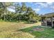 Spacious backyard with a gazebo-style covered seating area and mature trees at 468 E Oakwood Ave, Orange City, FL 32763