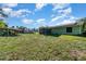 Large backyard with a gazebo, screen porch, solar panels, and ample green space at 468 E Oakwood Ave, Orange City, FL 32763