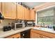 Functional kitchen with ample counter space, wooden cabinets, and essential appliances at 468 E Oakwood Ave, Orange City, FL 32763