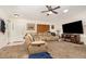 Comfortable living room featuring neutral carpet, ceiling fan, and a large sectional sofa at 468 E Oakwood Ave, Orange City, FL 32763