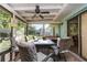 Relaxing screened patio with a table, chairs, and a ceiling fan, ideal for outdoor dining at 468 E Oakwood Ave, Orange City, FL 32763