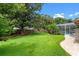 Green backyard with mature trees and manicured lawn at 5102 Round Tree Ct, Orlando, FL 32819