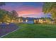 Wide shot of a beautifully landscaped backyard at dusk at 5102 Round Tree Ct, Orlando, FL 32819