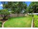 A spacious backyard is complemented by lush green grass and mature landscaping at 5102 Round Tree Ct, Orlando, FL 32819