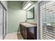 Modern bathroom features a glass shower and granite countertop vanity at 5102 Round Tree Ct, Orlando, FL 32819