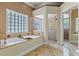 Relaxing bathroom with soaking tub, separate shower, and tile accents at 5102 Round Tree Ct, Orlando, FL 32819