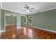 Cozy bedroom with hardwood floors, ceiling fan, and mirrored closet doors at 5102 Round Tree Ct, Orlando, FL 32819