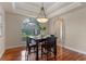 Elegant dining area with a modern chandelier, hardwood floors, and a table set for dinner at 5102 Round Tree Ct, Orlando, FL 32819