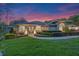 Charming home showcasing lush green lawn, beautiful landscaping, and inviting architecture at dusk at 5102 Round Tree Ct, Orlando, FL 32819