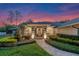 Well-maintained home featuring manicured landscaping, inviting front entrance, and exterior lighting at 5102 Round Tree Ct, Orlando, FL 32819