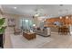 Open-concept living room showcasing comfortable seating, tile flooring, and a kitchen bar area at 5102 Round Tree Ct, Orlando, FL 32819
