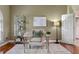 Cozy office with ample natural light, showcasing a glass desk, stylish decor, and hardwood floors at 5102 Round Tree Ct, Orlando, FL 32819