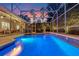 Backyard pool with screened enclosure and evening sky at 5102 Round Tree Ct, Orlando, FL 32819