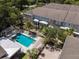 Aerial view showcasing community pool, townhomes, lush landscaping, and sidewalks at 528 Lanark Ct, Orlando, FL 32806