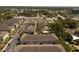 Aerial view of townhomes with manicured lawns and a nearby lake at 528 Lanark Ct, Orlando, FL 32806