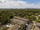 Aerial view showcasing townhomes with lush green trees and blue skies at 528 Lanark Ct, Orlando, FL 32806