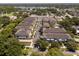 Aerial view of a residential community near a lake with mature trees and lush landscaping at 528 Lanark Ct, Orlando, FL 32806