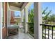 Relaxing balcony with comfortable seating and a view of lush greenery and flowering trees at 528 Lanark Ct, Orlando, FL 32806