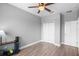 Cozy bedroom featuring neutral walls, wood-look floors, and a ceiling fan for added comfort and style at 528 Lanark Ct, Orlando, FL 32806