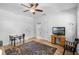 Bright bedroom featuring neutral walls, ceiling fan, wood-look floors, and a desk, offering comfort and style at 528 Lanark Ct, Orlando, FL 32806