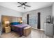 Bedroom with contemporary furnishings including a modern headboard, wood laminate flooring, and a ceiling fan at 528 Lanark Ct, Orlando, FL 32806