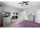 This bedroom includes a ceiling fan, adjoining bathroom, and laminate flooring at 528 Lanark Ct, Orlando, FL 32806