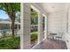 Inviting covered patio with seating area, lush landscaping, and view of the pool at 528 Lanark Ct, Orlando, FL 32806