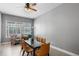 Elegant dining room with a glass-top table, modern chairs, and sun-filled windows overlooking the neighborhood at 528 Lanark Ct, Orlando, FL 32806