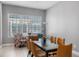 Bright dining room with a modern table, stylish chairs, and large windows providing ample natural light at 528 Lanark Ct, Orlando, FL 32806