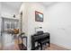Inviting entryway featuring a modern piano, artistic wallpaper, and seamless transition into the dining area at 528 Lanark Ct, Orlando, FL 32806