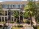 Exterior elevation showcasing townhome with landscaped yard, front porches, and stairs to the front doors at 528 Lanark Ct, Orlando, FL 32806