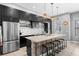 Contemporary kitchen with dark cabinets, stainless steel appliances, and a spacious island with seating at 528 Lanark Ct, Orlando, FL 32806
