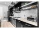 Modern kitchen featuring sleek black cabinets, stainless steel appliances, and white subway tile backsplash at 528 Lanark Ct, Orlando, FL 32806