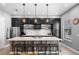 Spacious kitchen with dark cabinets, stainless steel appliances, a large island, and stylish pendant lighting at 528 Lanark Ct, Orlando, FL 32806