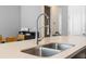 Close-up of kitchen island with stainless steel sink, modern faucet, and light countertops at 528 Lanark Ct, Orlando, FL 32806