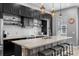 Modern kitchen featuring dark cabinetry, a large island with seating, and stainless steel appliances at 528 Lanark Ct, Orlando, FL 32806