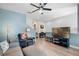 Stylish living room featuring a large TV, piano, comfortable seating, and contemporary decor at 528 Lanark Ct, Orlando, FL 32806