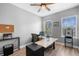 Well-lit office space with wood-look floors, a ceiling fan, and two large windows for a productive work environment at 528 Lanark Ct, Orlando, FL 32806