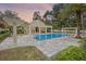Community pool with shade, lounge chairs, covered gathering spaces and manicured landscaping at 528 Lanark Ct, Orlando, FL 32806