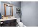Stylish powder room with modern vanity, sink, toilet, and decorative shelves, perfect for guests at 528 Lanark Ct, Orlando, FL 32806