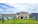 Spacious backyard with green lawn and a patio door; ideal for outdoor entertaining at 5345 Tuscany Ln, Davenport, FL 33897