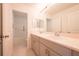 Modern bathroom with double sinks, a large mirror, and a door to the toilet and shower area at 5345 Tuscany Ln, Davenport, FL 33897
