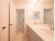 Bright bathroom featuring double vanity sinks, tile flooring, and access to a shower and toilet at 5345 Tuscany Ln, Davenport, FL 33897
