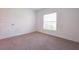 Bright bedroom with light carpet, white walls, and a window with natural light at 5345 Tuscany Ln, Davenport, FL 33897