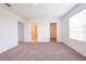 Large bedroom featuring wall to wall carpet and multiple open doorways to other rooms at 5345 Tuscany Ln, Davenport, FL 33897
